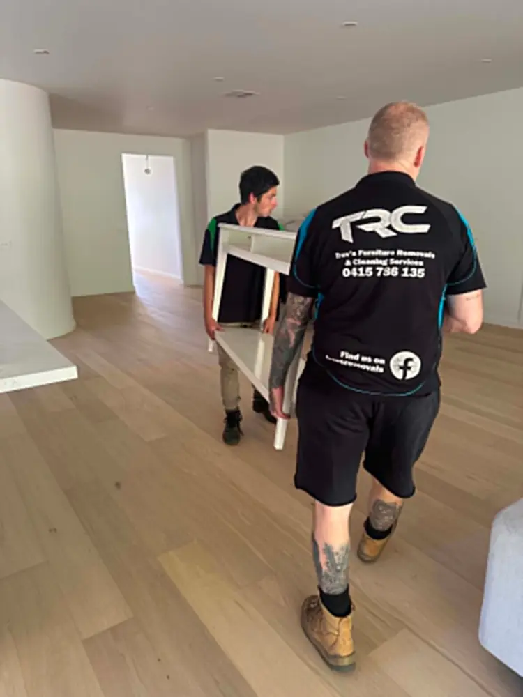 Trev's Removals crew carrying furniture through a Melbourne home