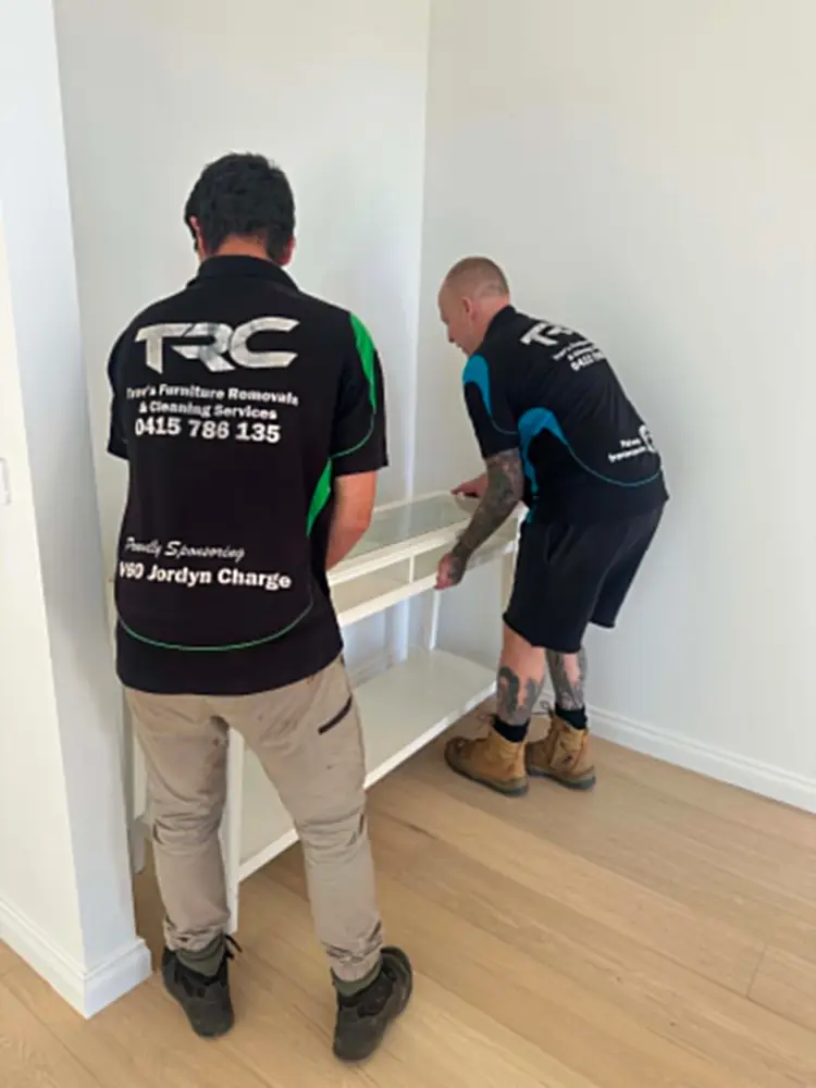 Trev's Removals team carefully lifting a console table during a Melbourne move
